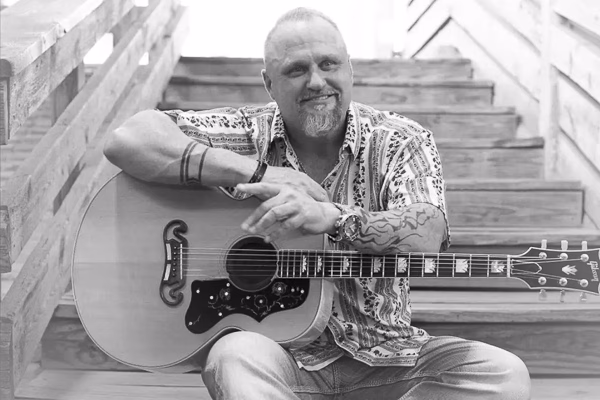 Dusty Moats performing live on stage, delivering an energetic country music experience with powerful vocals and engaging stage presence.